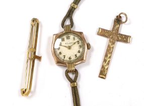 A lady's yellow metal manual wind wrist watch, the dial inscribed 'Rolex', a 9ct gold cross