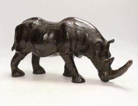 A leather rhinoceros figure with glass eyes, stamped Liberty to the underside, 54cm wide