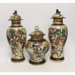 Three various Chinese crackleware famille rose jars and covers including a baluster example, largest