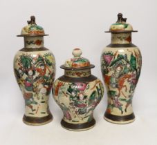Three various Chinese crackleware famille rose jars and covers including a baluster example, largest