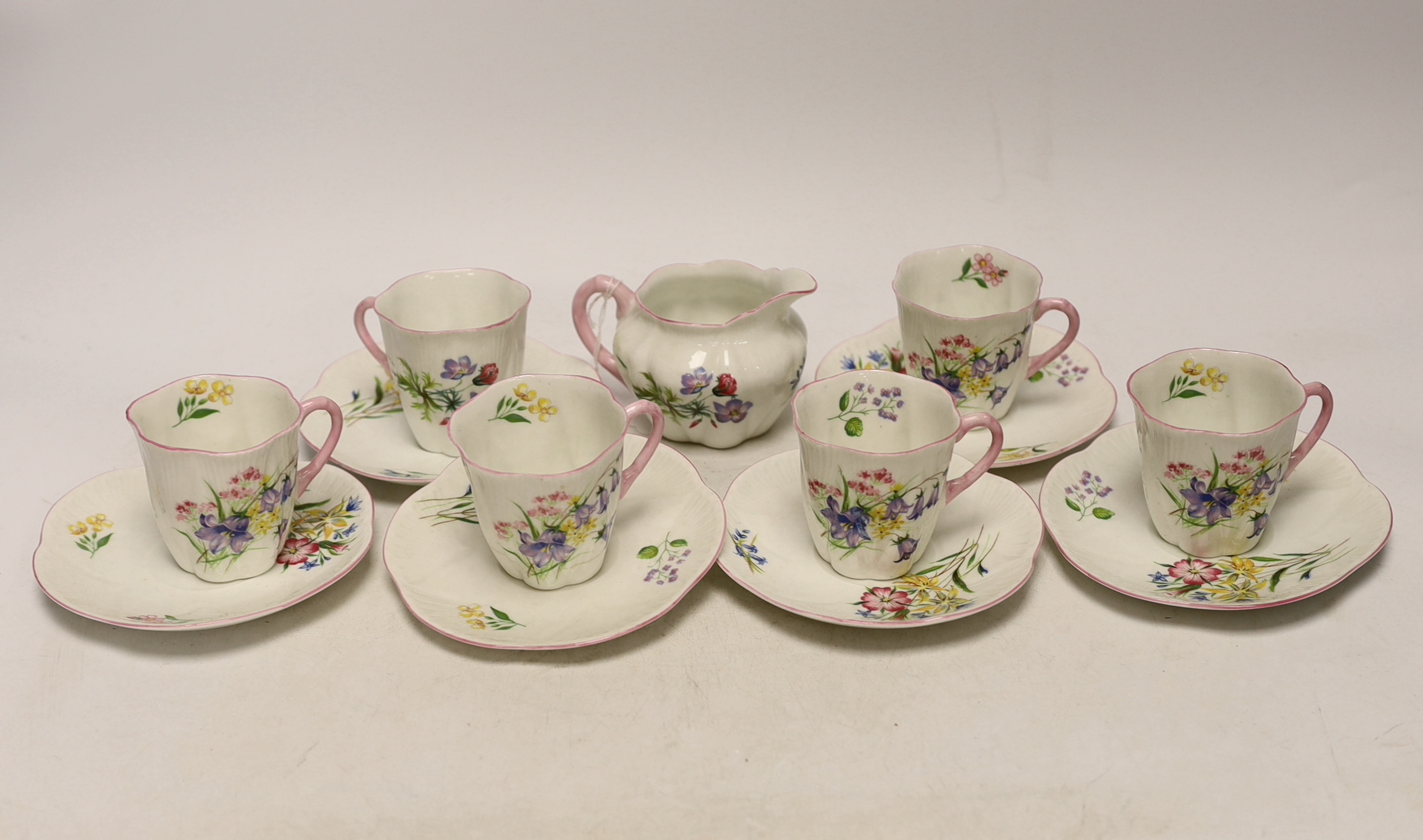 A Shelley 'wild flowers' bone china part tea set comprising milk jug and six cups and saucers