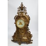 An ornately cast French bronze mantel clock, 57cm high