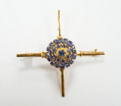 A yellow metal and sapphire cluster set brooch, of 'X' form with raised central motif, 45mm, gross