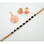 A modern 18ct and carved coral set 'rose' pendant, 16mm and a pair of matching ear studs and a