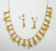 An early 20th century seed pearl and yellow chalcedony set drop necklace with yellow metal clasp,