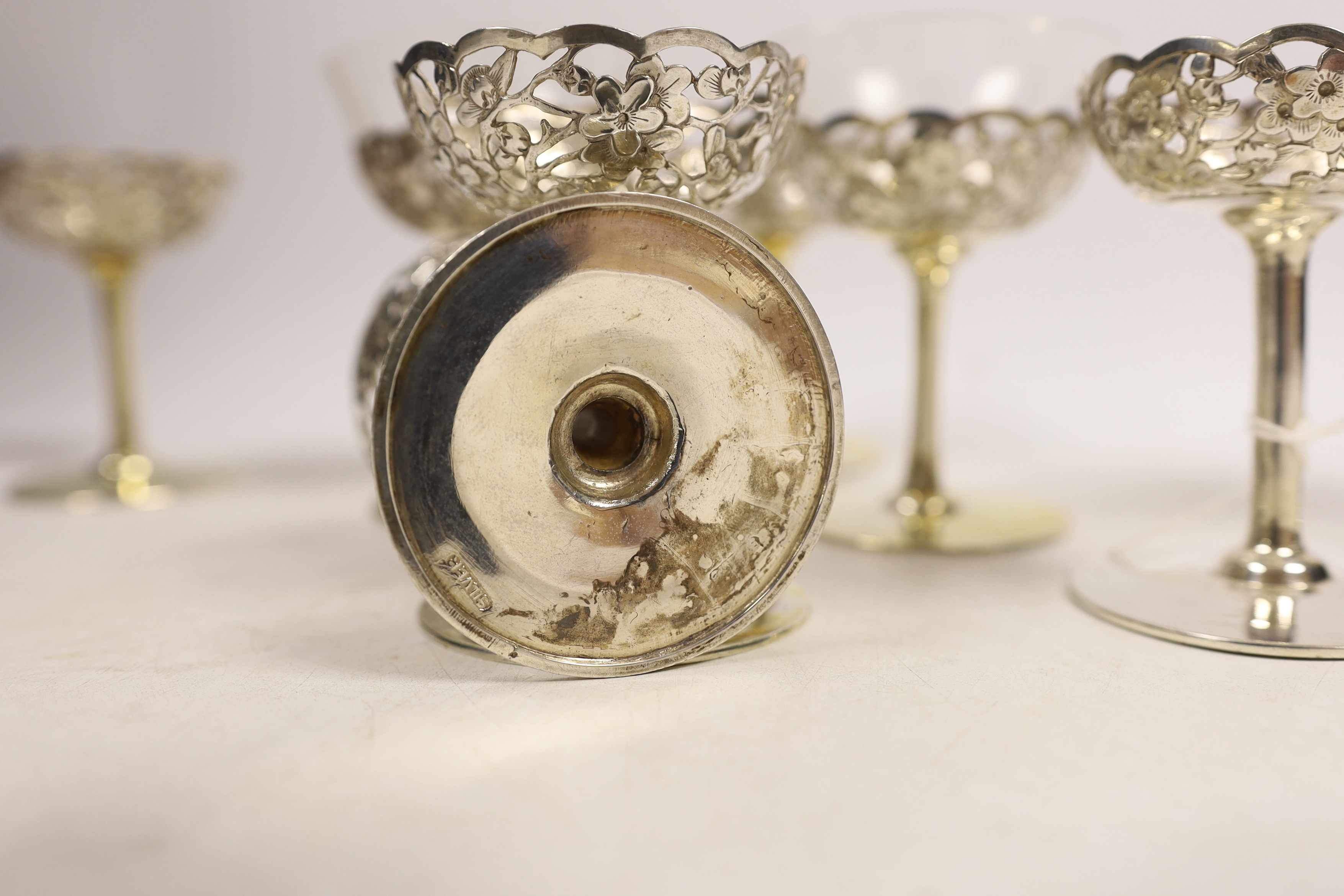 A matched set of eight pierced white metal coupes, two with glass inserts, six stamped with - Image 4 of 4