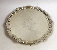 A George II silver salver, of shaped circular form, with shell and scroll border and engraved