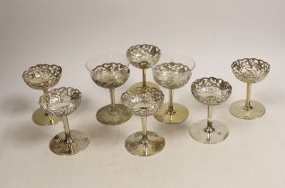 A matched set of eight pierced white metal coupes, two with glass inserts, six stamped with