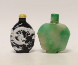A Chinese jadeite snuff bottle and a slip decorated porcelain ‘dragon’ snuff bottle