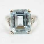 A white metal and single stone emerald cut aquamarine set ring, with rose cut diamond chip set