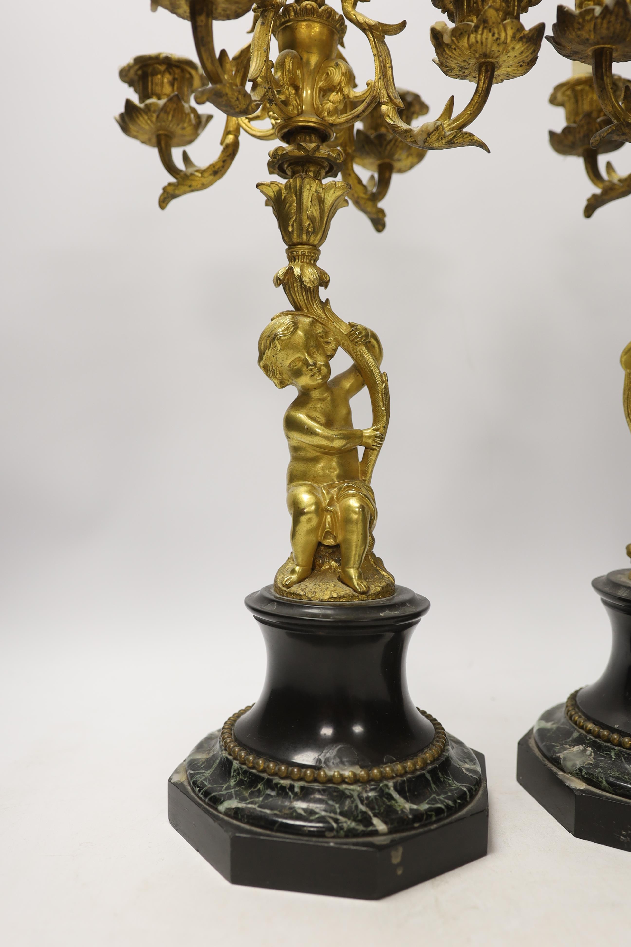 A pair of late 19th century French ormolu cherubic four branch candelabra on marble bases, 47cm - Image 2 of 4