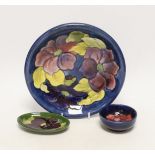A Moorcroft Pansy plate, pin dish and a small bowl, 22cm in diameter