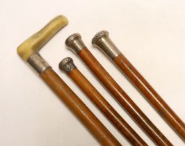 Four silver topped walking canes, one with antler handle