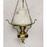 A pair of brass hanging lights with opaque glass shades