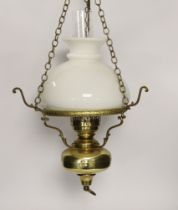 A pair of brass hanging lights with opaque glass shades