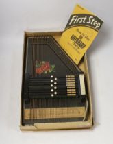 An autoharp in original box with booklet