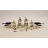 A silver condiment set comprising two salts, two peppers, two pepperettes and four spoons,