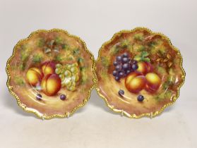 A pair of Royal Worcester fruit painted plates, post war, signed Freeman, 22.5cm