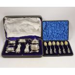 An Edwardian cased silver seven piece condiment set with four matching spoons, Hukin & Heath,