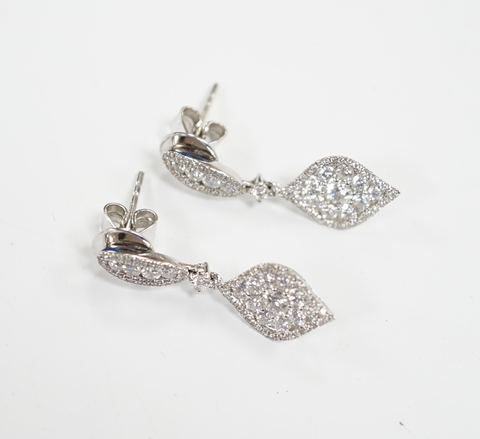 A modern pair of 750 white metal and diamond cluster set drop earrings, of elliptical form, 26mm,