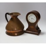 A copper measure jug and a mantel clock