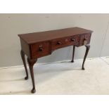 A mahogany three drawer console table, width 105cm, depth 36cm, height 73cm