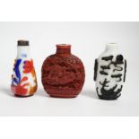 Three Chinese snuff bottles including a 19th century cinnabar lacquer ‘boys’ snuff bottle, largest