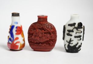 Three Chinese snuff bottles including a 19th century cinnabar lacquer ‘boys’ snuff bottle, largest