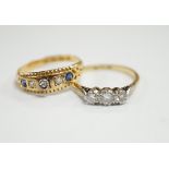 An 18ct, plat and three stone diamond set ring, size K and a late Victorian 18ct gold three stone
