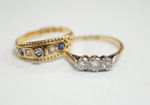 An 18ct, plat and three stone diamond set ring, size K and a late Victorian 18ct gold three stone