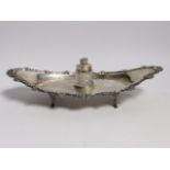 A late Victorian silver navette shaped inkstand, with silver mounted cut glass well, on four