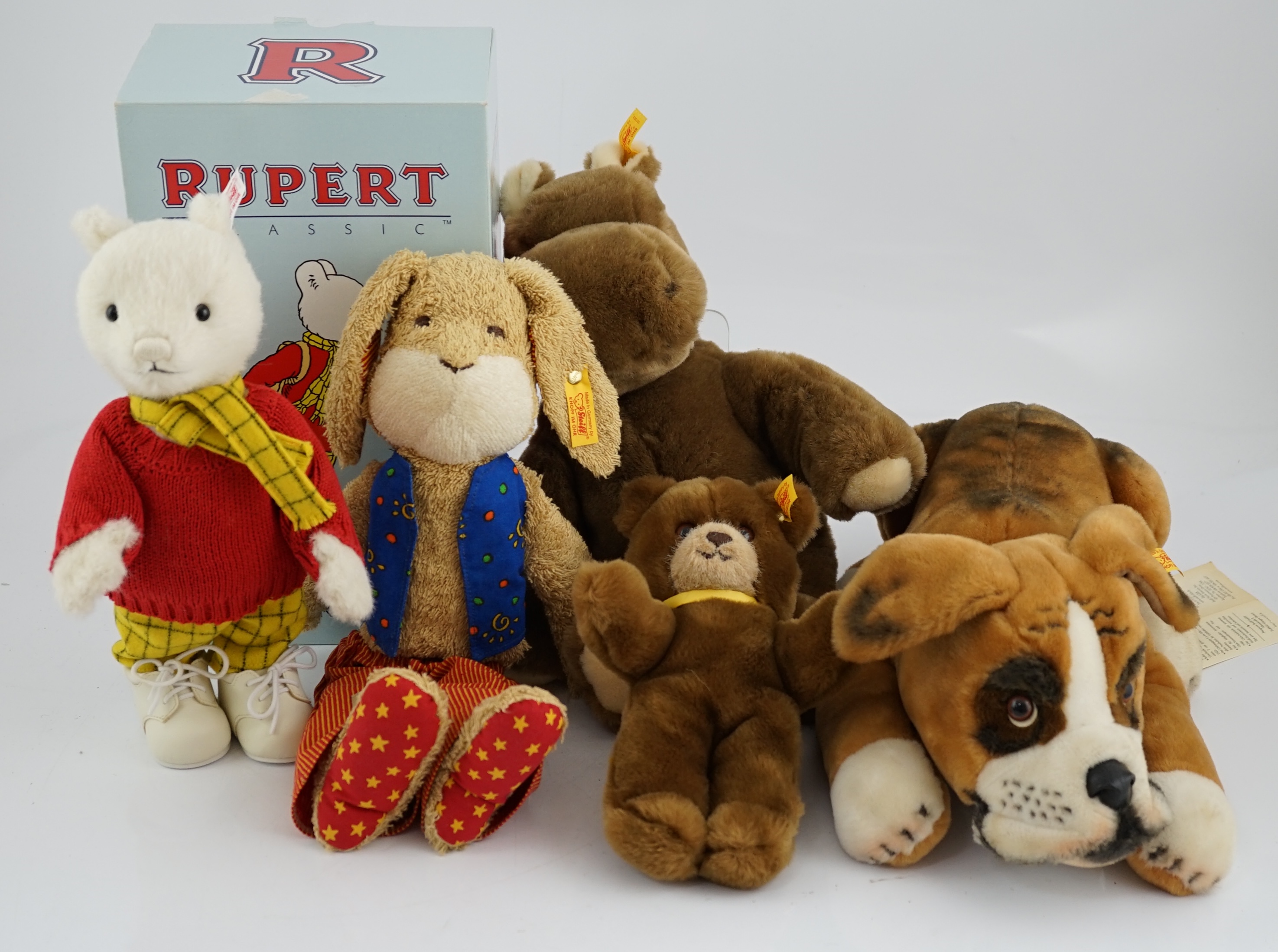 Four Steiff toys including Boxer dog and Rupert Bear