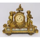A late 19th century French ormolu mantel clock surmounted with cherubs, 31cm