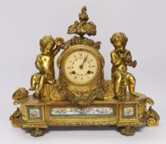 A late 19th century French ormolu mantel clock surmounted with cherubs, 31cm
