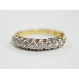 A modern 750 yellow metal and nine stone diamond chip set half hoop ring, size I/J, gross weight 3.1