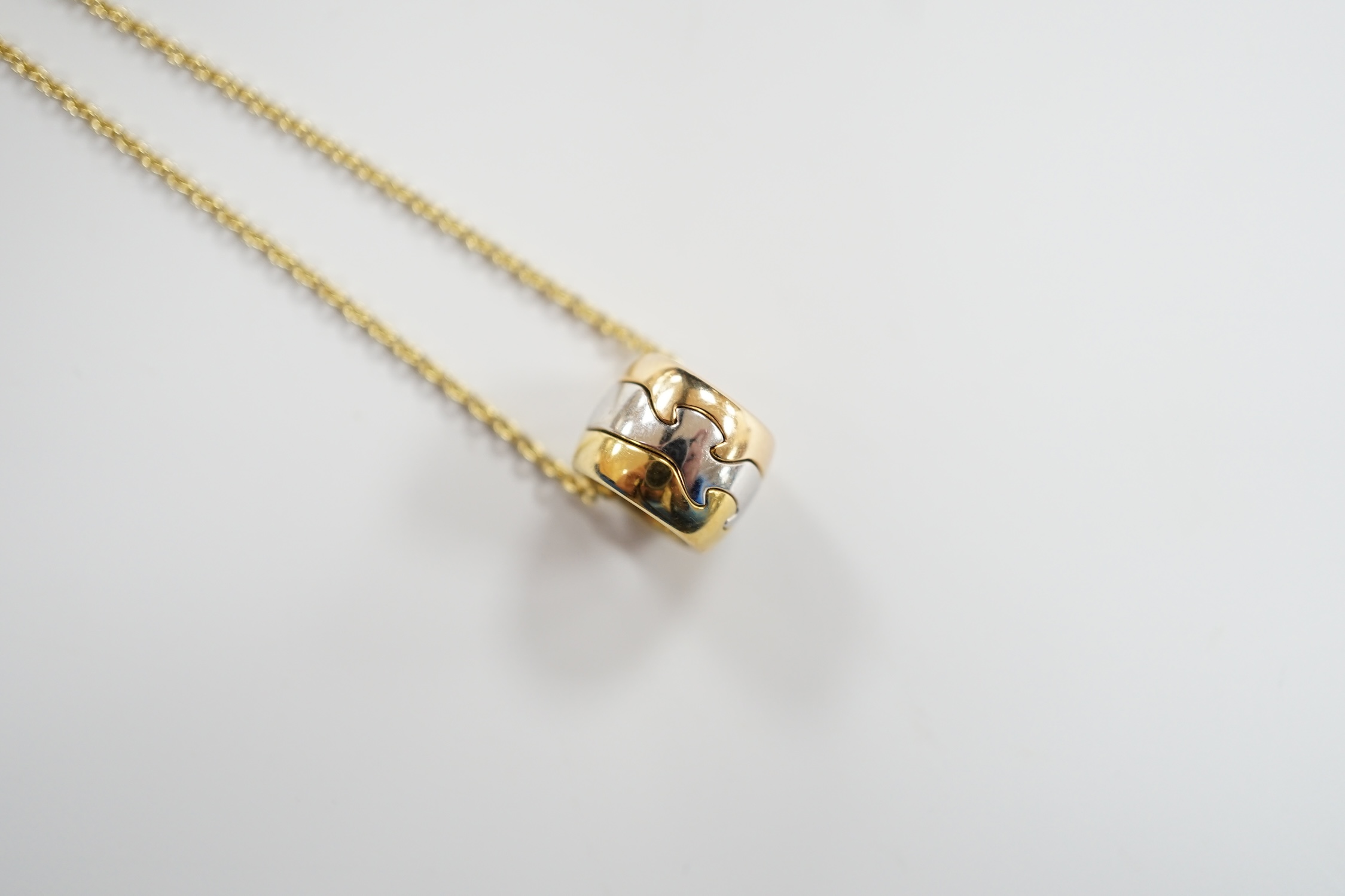 A modern Georg Jensen two colour 18ct gold barrel pendant, 10mm, on a Georg Jensen 18ct gold fine