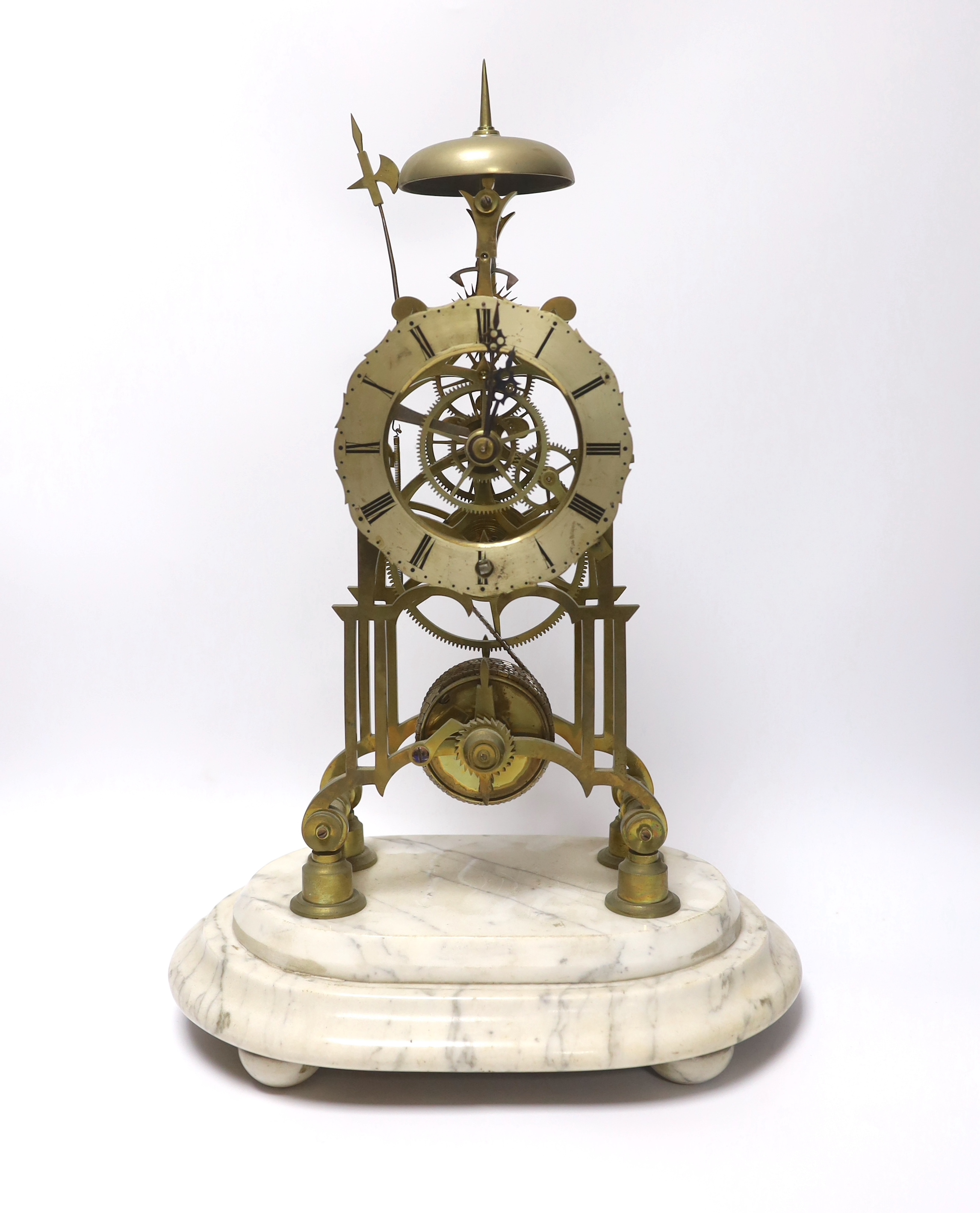 A skeleton clock with Roman numeral dial, raised on white marble base, pendulum and key, 45cm