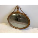 A Sheraton style oval giltwood and composition wall mirror, width 80cm, height 80cm