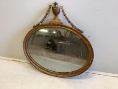 A Sheraton style oval giltwood and composition wall mirror, width 80cm, height 80cm