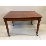 An early Victorian rectangular mahogany table, raised on fluted legs and brass castors, width 111cm,