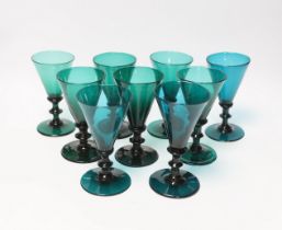 Nine early 19th century green wine glasses, 14cm