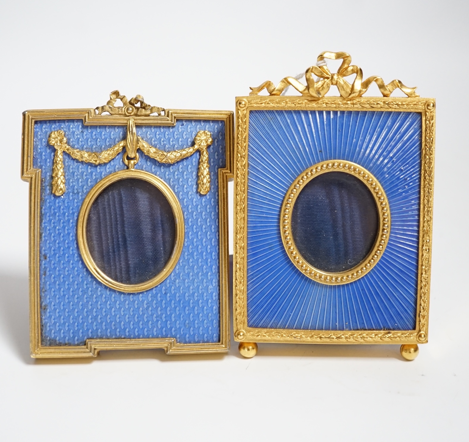 Two gilt metal and enamel miniature frames with fitted cases, largest 11cm high