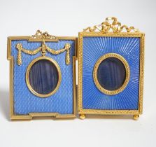 Two gilt metal and enamel miniature frames with fitted cases, largest 11cm high