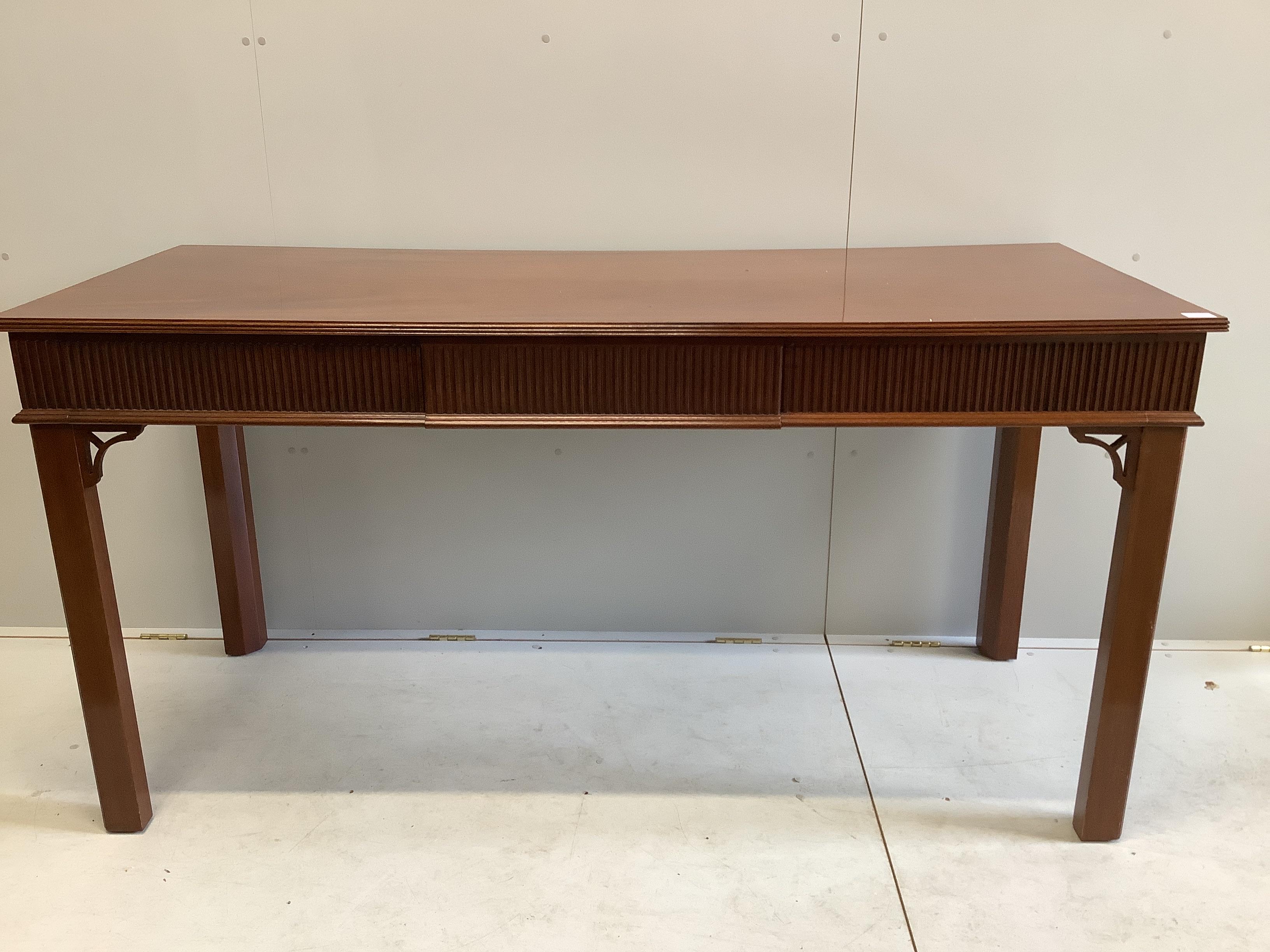 A George III style mahogany serving table, fitted three frieze drawers, the back incorporating two