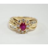 A modern 14k, ruby and diamond set oval cluster dress ring, with diamond chip set shoulders, size P,