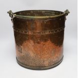 A copper and brass cylindrical log bucket, with swing handle, 33cm high