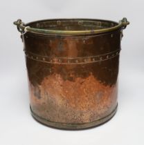 A copper and brass cylindrical log bucket, with swing handle, 33cm high
