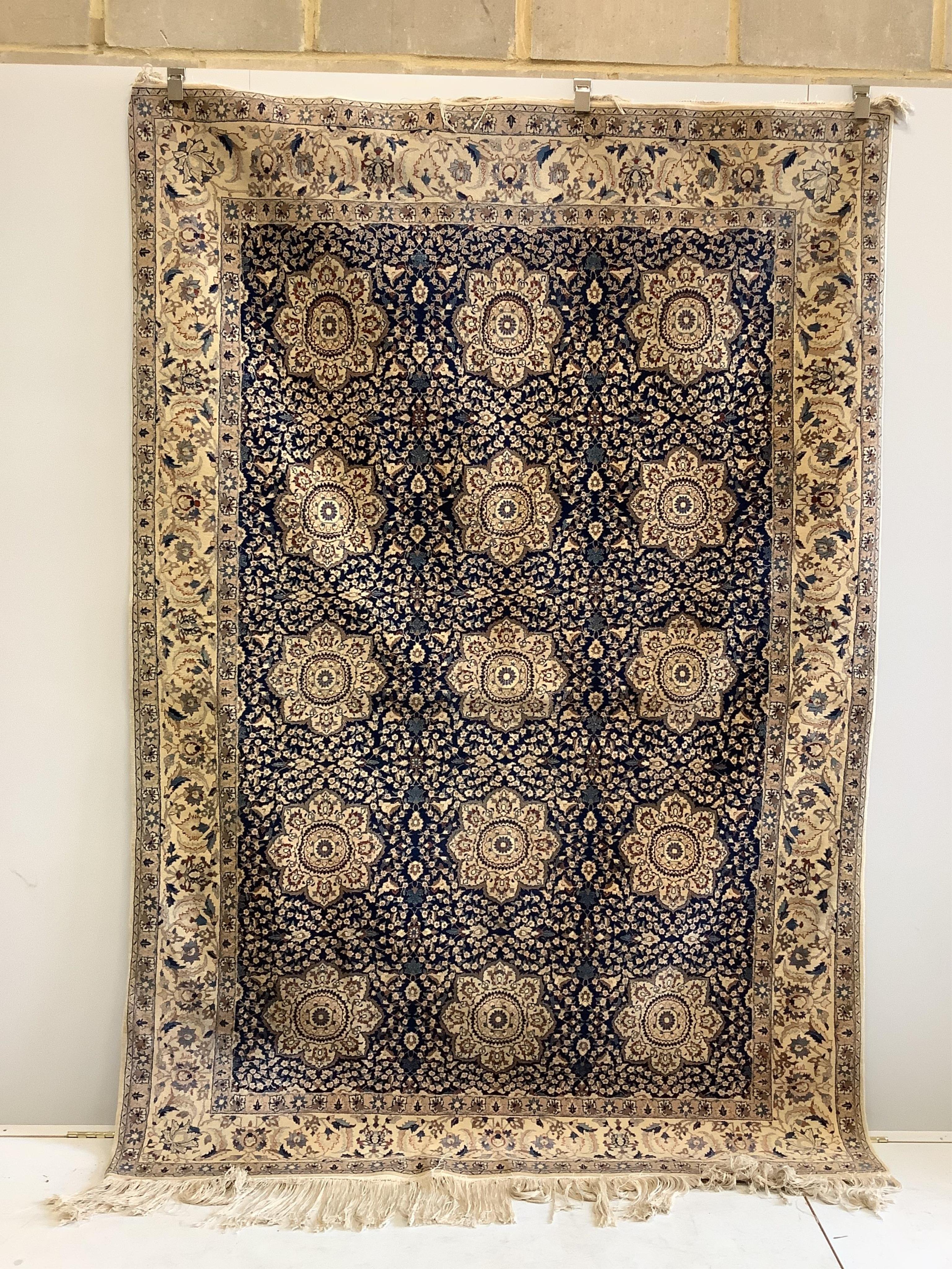 A North West Persian blue and ivory ground carpet with floral borders, 250 x 168cm