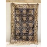 A North West Persian blue and ivory ground carpet with floral borders, 250 x 168cm