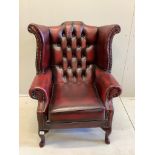 A Victorian style buttoned burgundy leather wing armchair, width 80cm, depth 70cm, height 104cm
